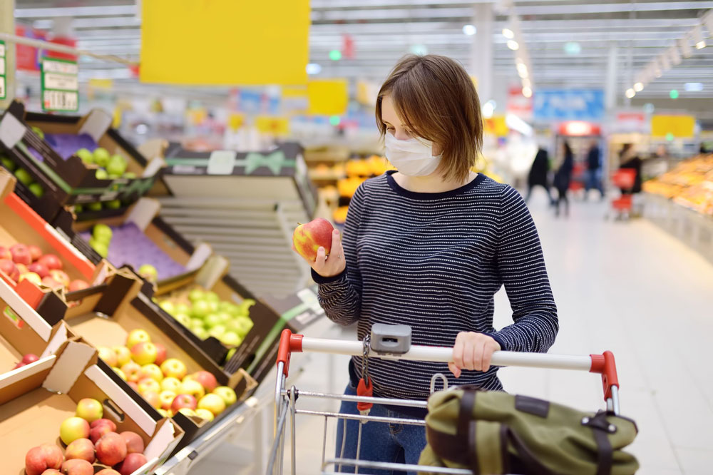woman shops with a mask