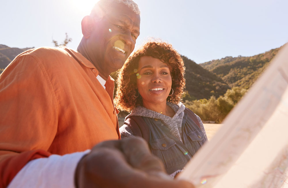 man and woman in nature looking at map