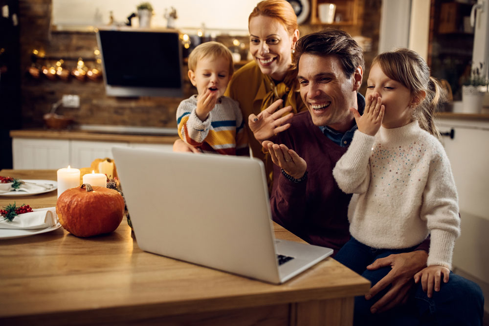 family takes virtual call during holiday dinner