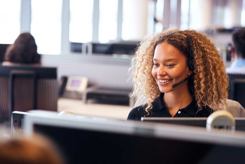 woman with headset in cubicle