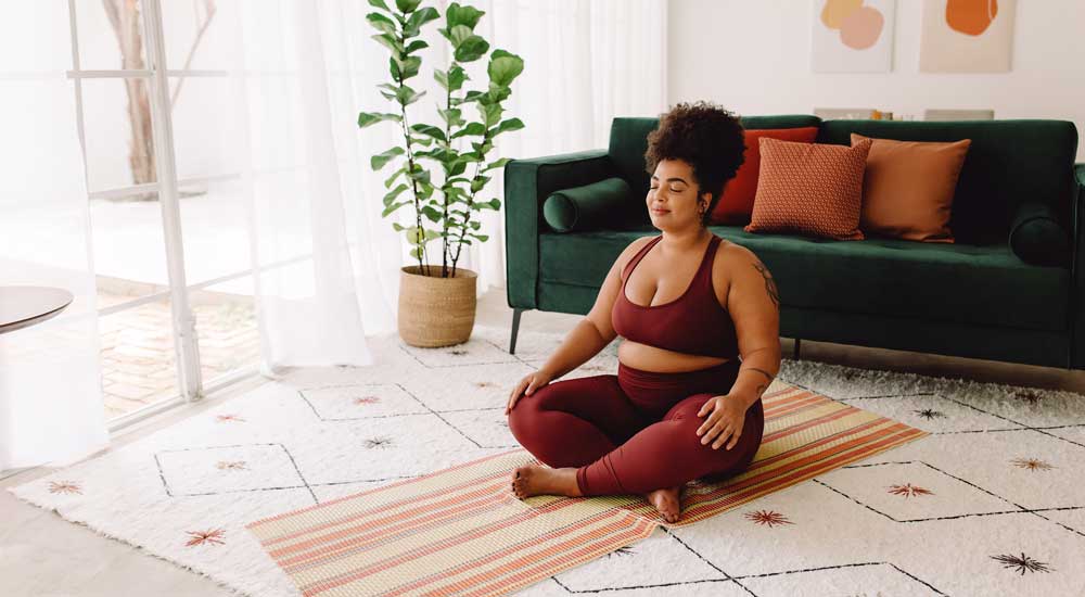 woman sitting on yoga mat