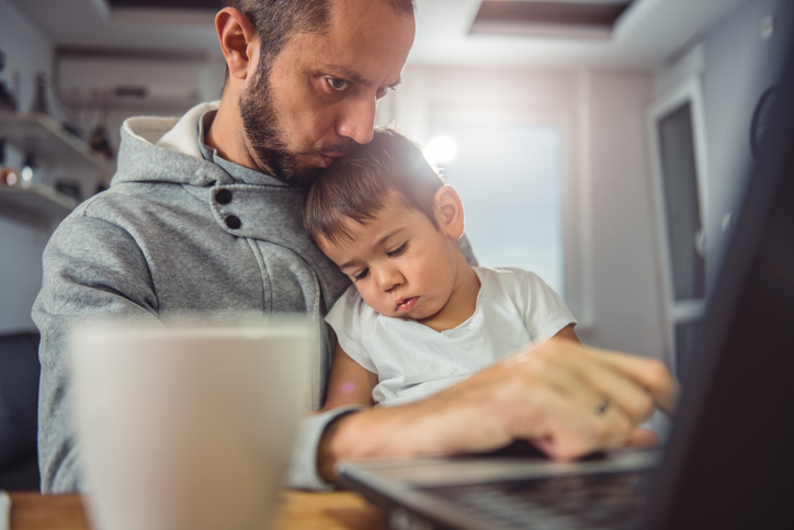 man working at home with children