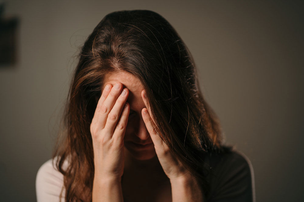 woman with her head in her hands