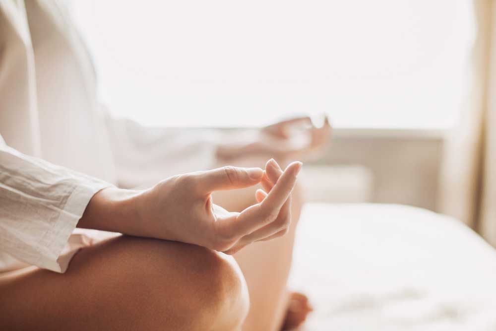 Close up of hands of Yoga woman meditating and practicing yoga at home
