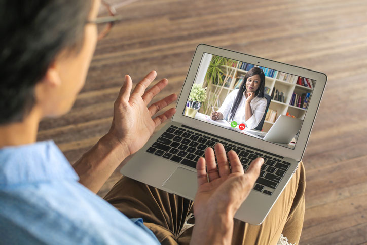 man talks with doctor on computer