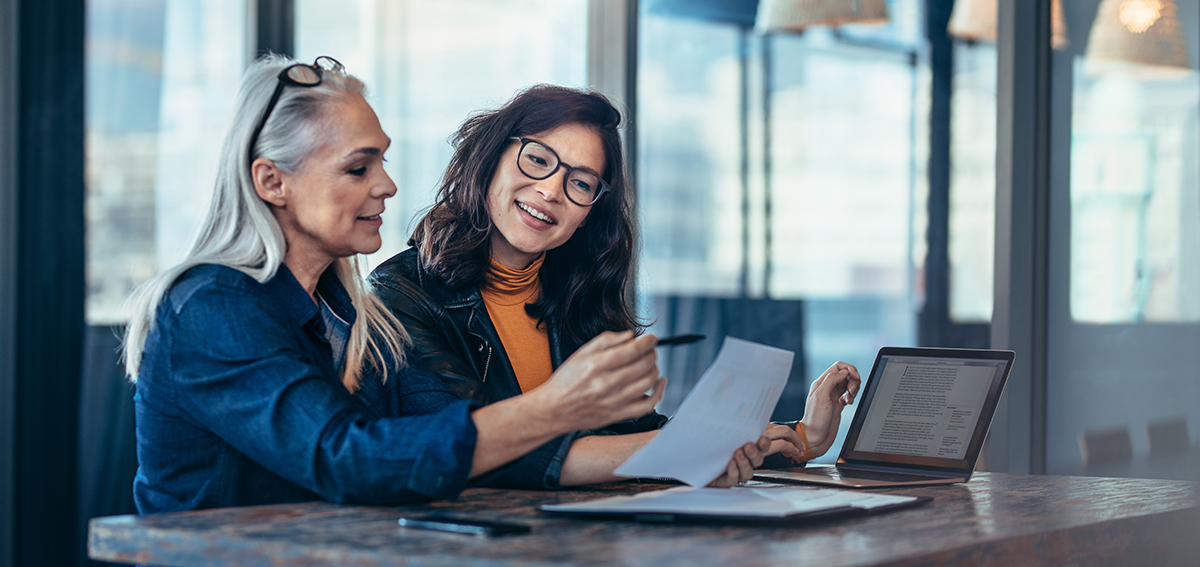 Two female small business owners reviewing a report