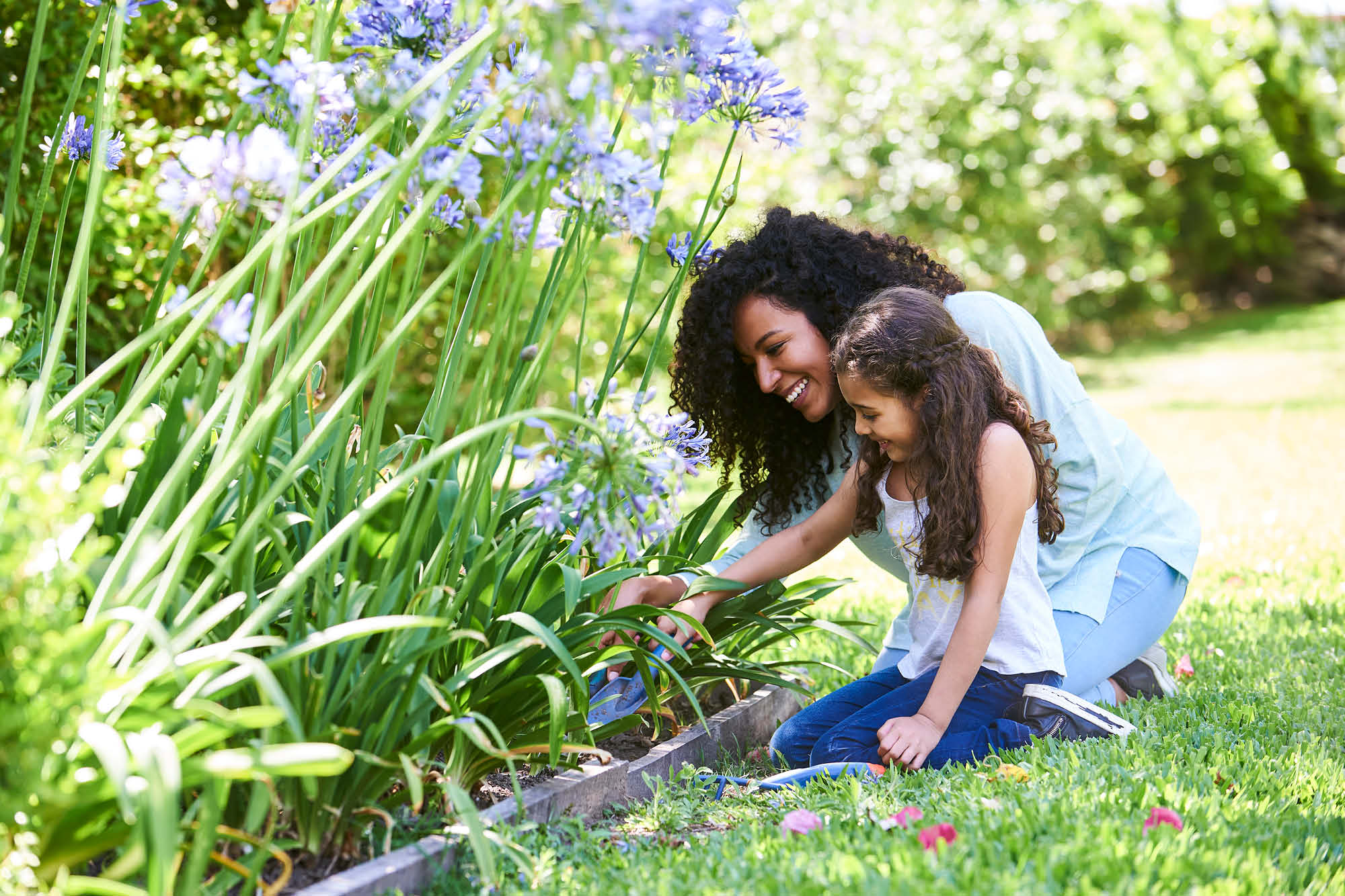 woman and young daughter picking flowers