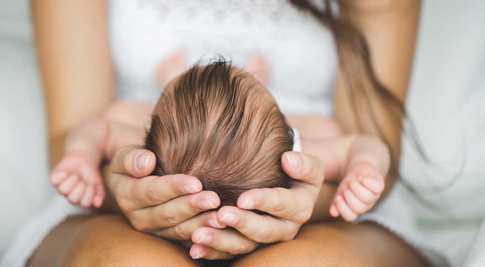 woman holding a new baby